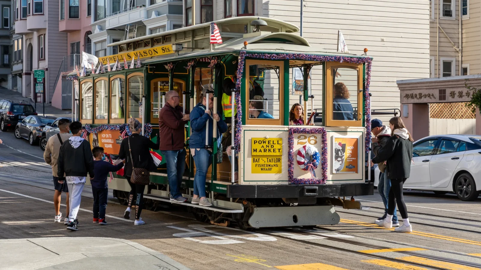 Passengers boarding a cable car at a stop on Mason Street in San Francisco