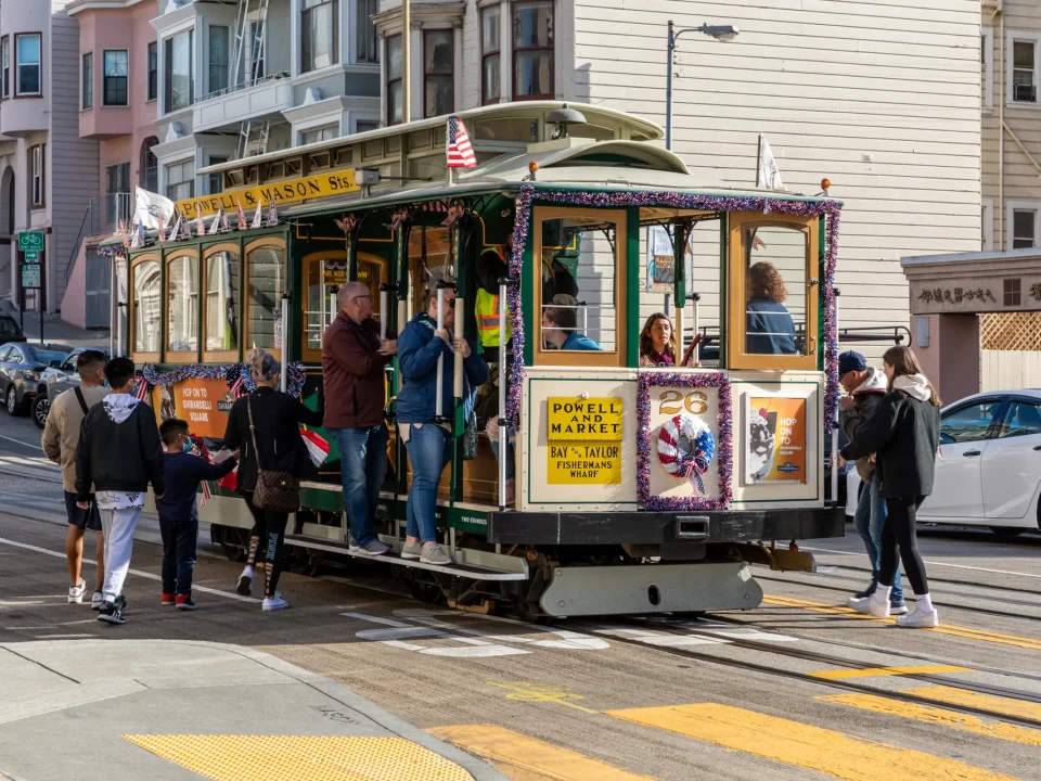 Passengers boarding a cable car at a stop on Mason Street in San Francisco